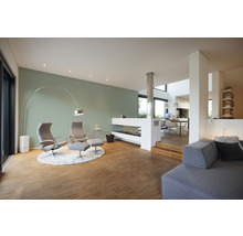 Lichte woonkamer met fauteuils, open haard en houten vloer