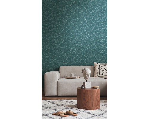 Woonkamer met patroonbehang, bank en bijzettafel