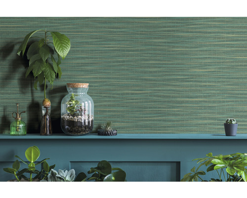 Decoratieve kamerplanten en een groen structuurbehang op een plank