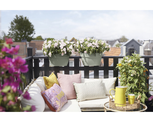 Gedecoreerd balkon met bloembakken, kussens en tuinmeubilair voor een gezellige sfeer