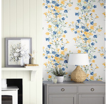 Decoratief interieur met behang met bloemmotief, commode, lamp en open haard.