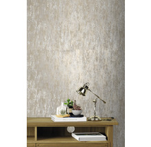 Close-up van een gestructureerd behang boven een houten meubel met lamp en decoratie