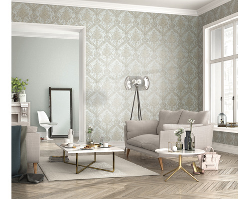 Woonkamer met patroonbehang, bank, salontafel en vloerlamp