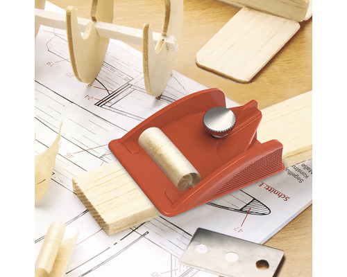 Schaafmes met houtsnippers op een plan