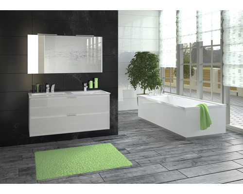 Badkamer met wastafel, spiegel, bad en vloerkleed