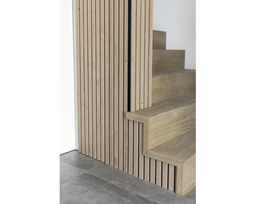 Detailopname van een trap met houten bekleding en een wand met houten panelen.