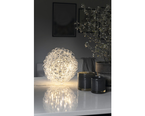 Decoratief LED lichtobject in bolvorm op een tafel