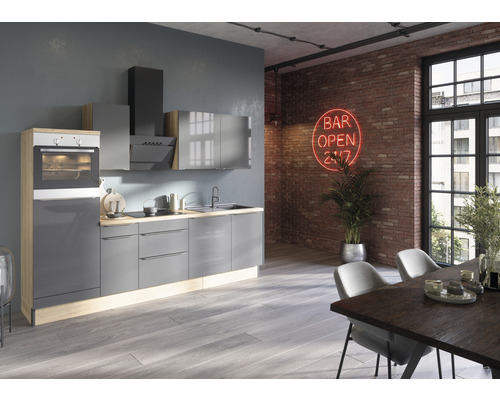 Moderne keuken met grijze kasten, afzuigkap en oven in een lichte ruimte met eettafel