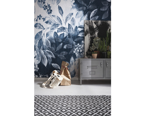 Kamerzicht met bloemenbehang, metalen kast, schilderij, kamerplanten en tapijt met geometrisch patroon