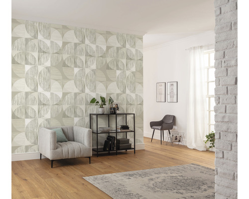 Woonkamer met patroonbehang, fauteuil, plank en decoratie