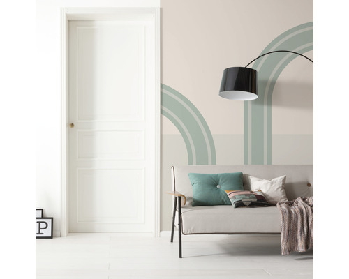 Woonkamer met deur, bank, vloerlamp en wanddecoratie met geometrische vormen