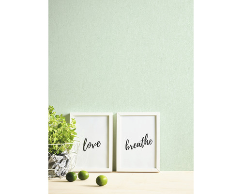 Decoratieve scène met ingelijste kunstdrukken, potplant en limoenen