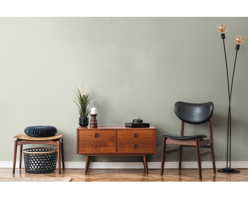 Woonkamer met ladekast, stoel, kruk en staande lamp