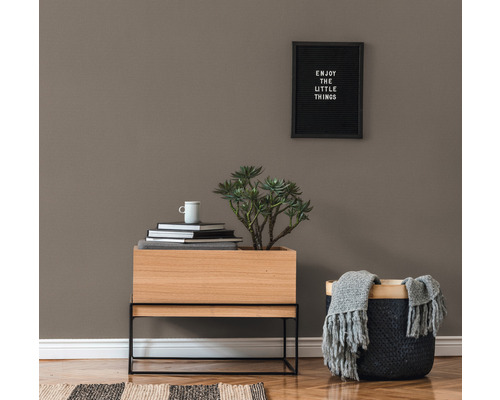 Decoratief interieur met plant, stapel boeken, mand en wandbord