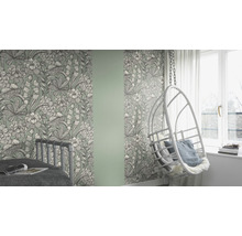 Kamer met bloemenbehang, bed en hangstoel