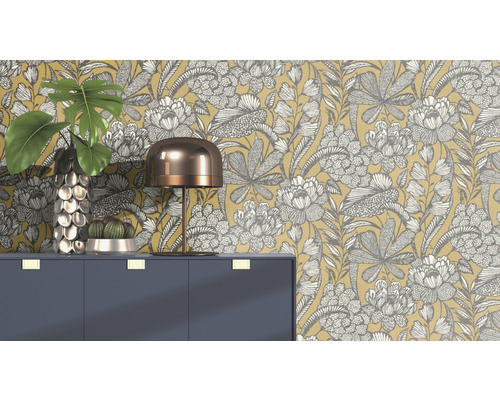 Decoratieve scène met bloemenbehang, ladekast, lamp, vaas en cactus