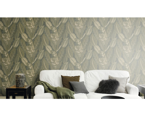 Woonkamer met witte bank en behang met bladmotief