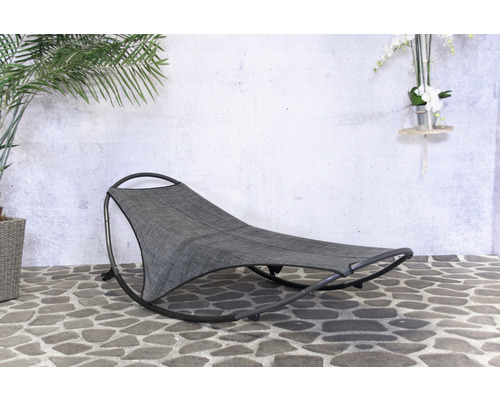 Grijze schommelstoel voor buiten op stenen vloer