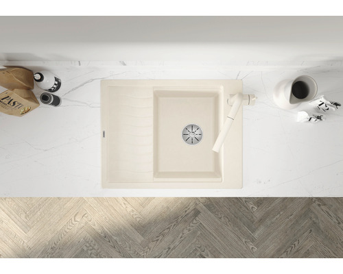 Afbeelding van een beige gootsteen met afdruiprek