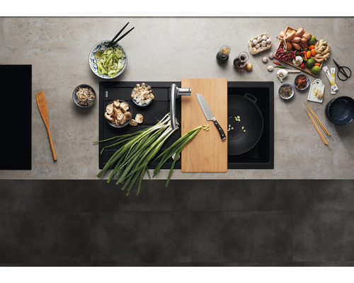 Keukenspoelbak met kraan, snijplank, mes, wokpan en diverse ingrediënten voor het bereiden van Aziatische gerechten.