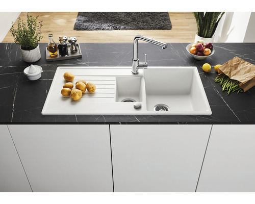 Keuken spoelbak met afdruiprek, kraan en diverse voedingsmiddelen op een aanrecht