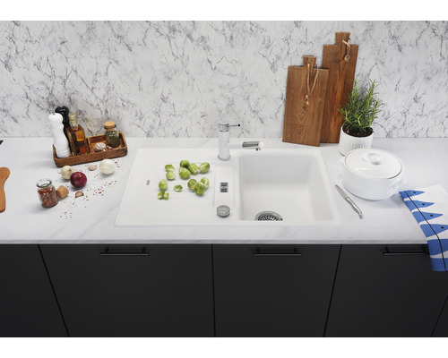 Spoelbak met afdruiprek, kraan en diverse keukengerei op een aanrecht
