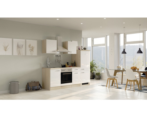 Lichte inbouwkeuken met elektrische apparaten en eethoek in een modern ingerichte ruimte.