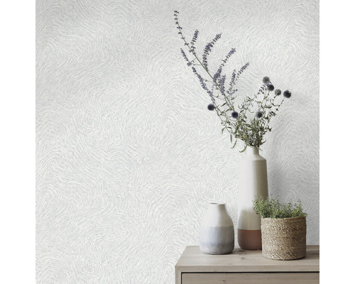 Decoratief behang met golvend patroon en vazen met bloemstuk op een tafel