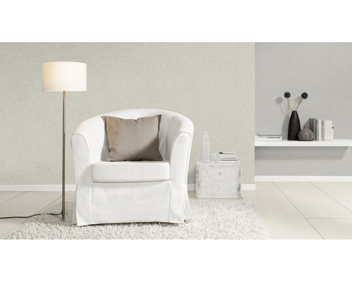 Woonkamer met fauteuil, staande lamp en decoraties