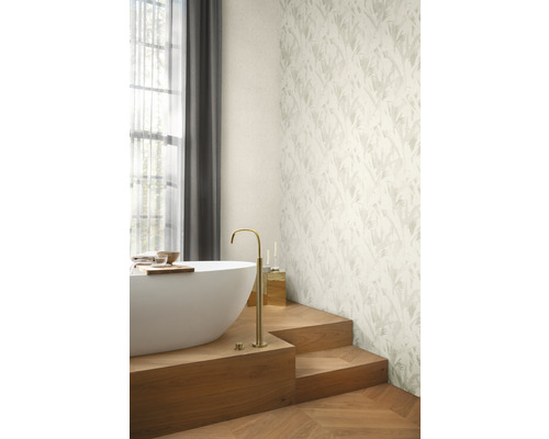 Badkamer met ligbad, armatuur en behang met patroon