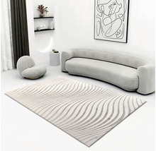 Woonkamer met vloerkleed met golfpatroon, bank en fauteuil