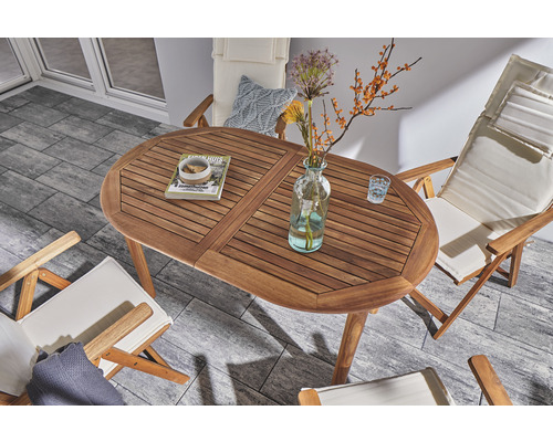 Tuinopstelling met ovale houten tafel en bijpassende stoelen