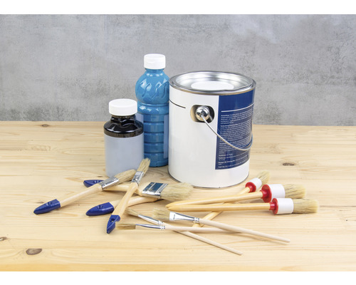 Verfemmer, lakfles en penselen op een houten tafel