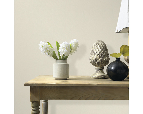 Decoratieve elementen op een houten tafel voor een muur.