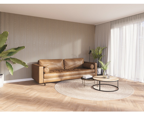 Woonkamer met bruine leren bank, twee salontafels en houten lambrisering