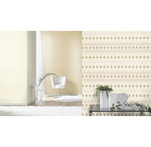 Woonkamer met patroonbehang, fauteuil, tapijt en decoratie