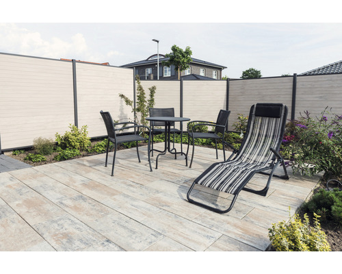 Terras met privacyscherm, tuintafelset en ligstoel