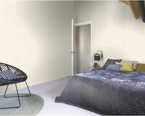 Slaapkamer met bed, stoel, vloerkleed en open deur