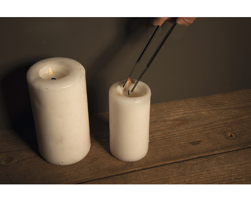 Kaars wordt bijgesneden met een kaarsenschaar