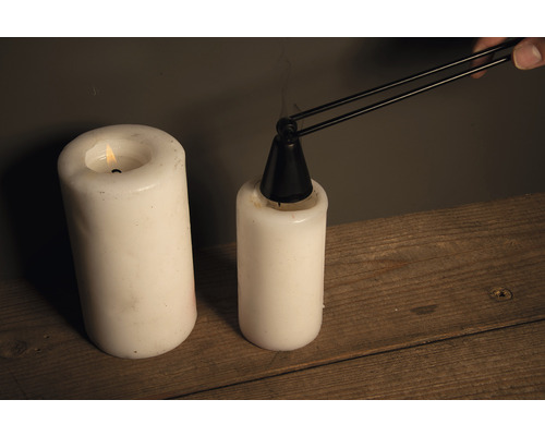 Kaars met kaarsendover op een tafel