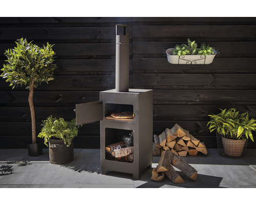 Buitenscène van een stalen pizzaoven met hout en potplanten