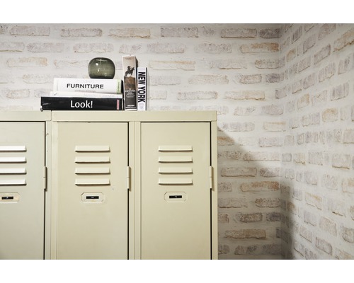 Metalen locker met decoratie en stapel boeken voor een muur met steeneffect