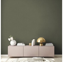 Woonkamer met dressoir, decoraties en tapijt op een lichte houten vloer