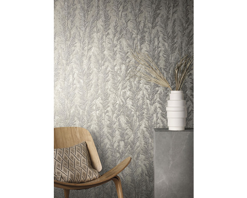 Kamerweergave met gestructureerd behang met plantmotief, een houten stoel en een witte vaas.