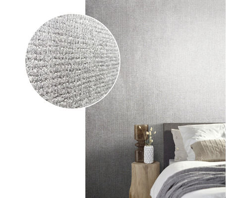 Slaapkamer met grijs structuurbehang en een uitvergrote detailweergave van het behang oppervlak.