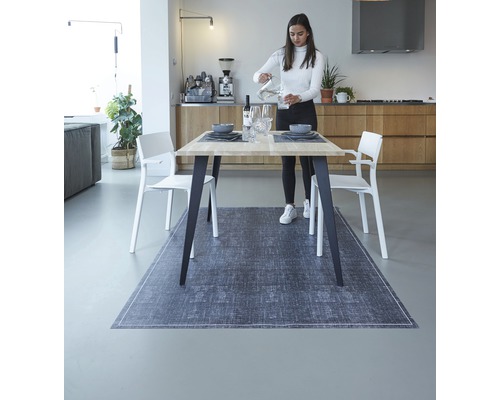 Lichte eetkamer met eettafel, stoelen en donkergrijs vloerkleed