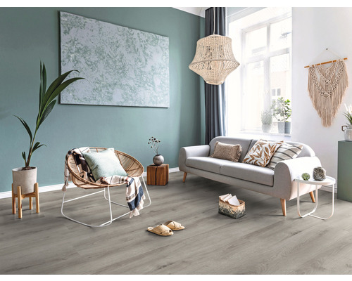 Lichte woonkamer met bank, fauteuil, decoratie en grijze vloerbedekking