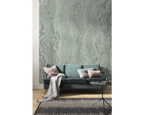 Woonkamer met bank, tapijt en behang met abstract patroon