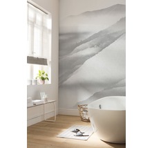 Badkamer met ligbad en foto behang met bergmotief