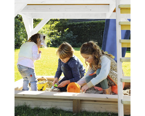 Kinderen spelen in de zandbak met dak op een speelplaats.